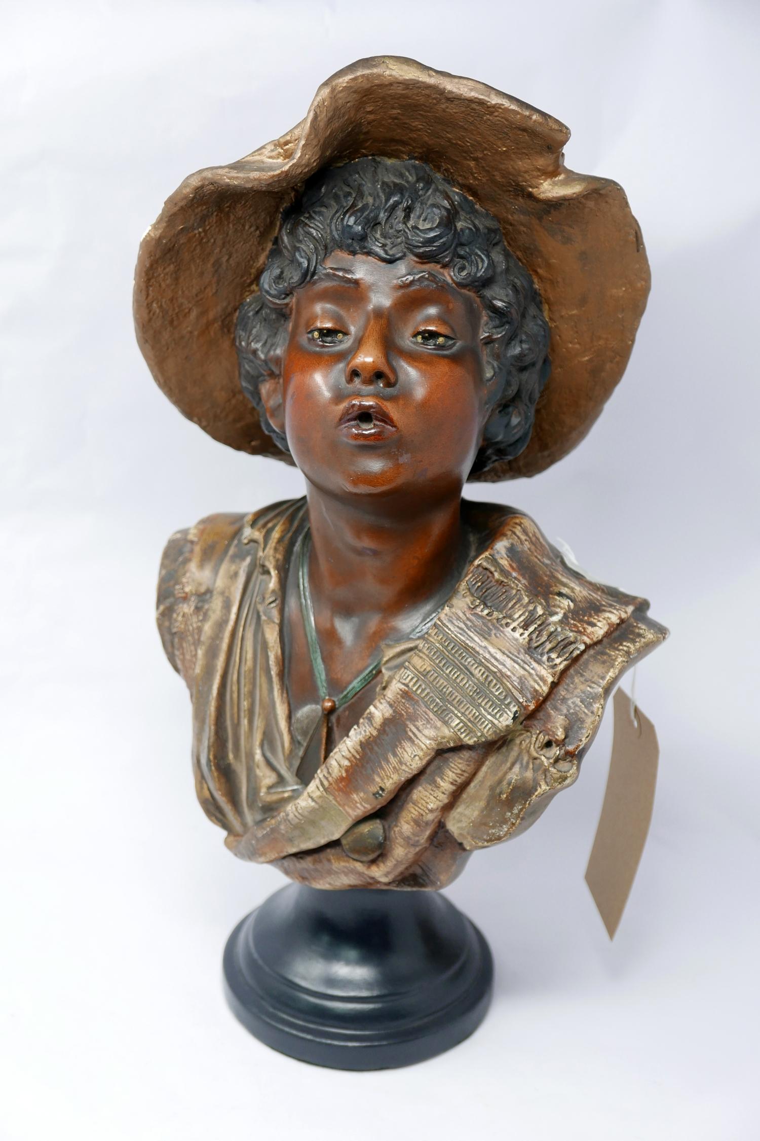 A 19th century plaster bust of young boy in a hat, on socle base, H.49cm