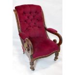 A Victorian mahogany scroll armchair, with burgundy velour button back upholstery, raised on