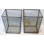 A pair of pierced metal waste baskets