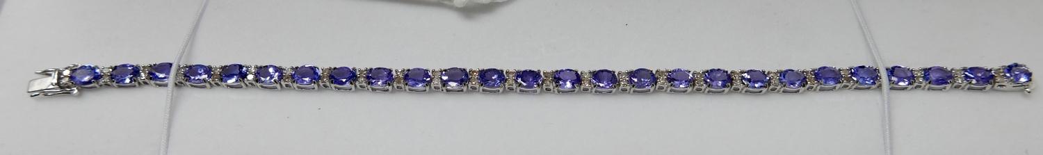 A boxed 18ct white gold diamond and tanzanite tennis bracelet composed of alternating stones to a - Bild 5 aus 5