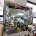 A large contemporary mirror, with bevelled and mirrored glass frame, 110 x 110cm