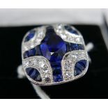 A boxed platinum Art Deco style ring, with diamonds and sapphires set to the centre with an oval,