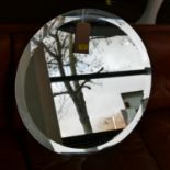 A large circular bevelled glass wall mirror, dia: 60cm