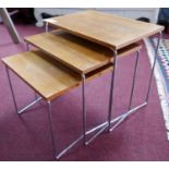 A nest of 3 mid 20th century vintage teak tables of compact size on tubular chrome supports, H.39