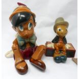 A vintage hand-carved figure of Pinocchio, hand-coloured and marked to base 'Made in USA by Walt