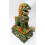 An early 19th century glazed Dog of Fo, seated on pierced rectangular base, stamped to base, H.30cm