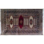 A 20th century signed Afghan rug, triple geometric medallion, geometric borders, 102 x 62cm