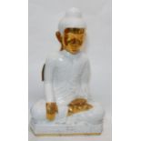 A large white and gold ceramic model of a seated Buddha, H.79 W.48 D.32cm