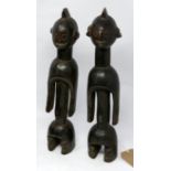 A pair of African tribal fertility figures, possibly Senufo, H.38cm