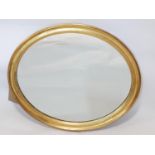 A gilt painted oval wall mirror, 56 x 46cm