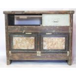 An early 20th century industrial work bench, with remnants of factory green paint and gilt gesso