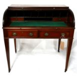 A Georgian mahogany roll top desk, the tambour front above two drawers, raised on tapered legs and