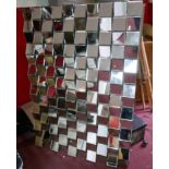 A large wall mirror with unusual geometric multi-faceted plate, H.100 W.140cm