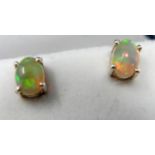 A boxed pair of sterling silver and natural oval-shaped opal cabochon stud earrings, Gross: 1.5g