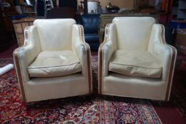 A pair of Art Deco cream leather and walnut armchairs