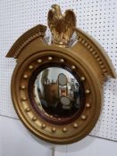 A Regency style gilt convex wall mirror with eagle surmount, H.67 W.57cm