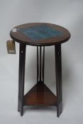 An Arts and Crafts mahogany jardiniere stand with tile top, H.69cm