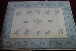 A large woolen carpet with floral design on a cream ground, 313 x 230cm