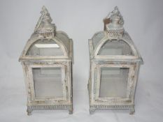 A pair of distressed painted storm lanterns, H.50cm (2)