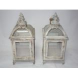 A pair of distressed painted storm lanterns, H.50cm (2)