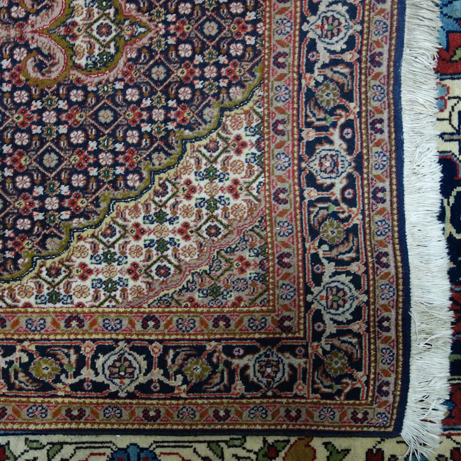 A part silk Tabriz rug, with floral medallion, on a blue and beige ground, contained by floral - Image 2 of 3