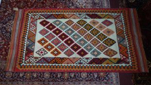 A South West Persian Qashqai kilim, repeating stylised geometric motifs on an ivory field within