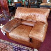 A pair of 1970's Roche Bobois brown leather armchairs