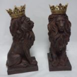 A pair of resin lions with gilt painted crowns, H.55cm