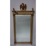 A Regency style pier mirror, with eagle finial above reeded columns, 143 x 71cm