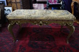 A gilt piano stool with tapestry upholstered seat, H.47 W.94 D.42cm