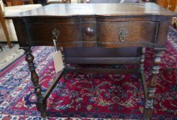 An early 20th century oak side table by James Shoolbred & co, with makers label, H.73 W.82 D.50cm