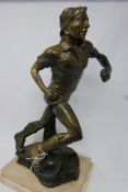A vintage Continental cast metal figure of a footballer. H.44cm