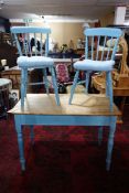 A painted pine kitchen table with drawer, H.73 W.107 D.59cm together with two matching chairs