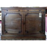 An early 19th century mahogany sideboard, two drawers over two cupboard doors, raised on stepped