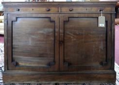 An early 19th century mahogany sideboard, two drawers over two cupboard doors, raised on stepped