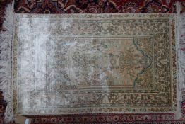 A 20th century silk Turkish Hereke rug, with birds and floral design, 124 x 75cm