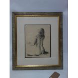 A framed and glazed charcoal drawing of a nude signed K Maunder. H.35 W.29cm