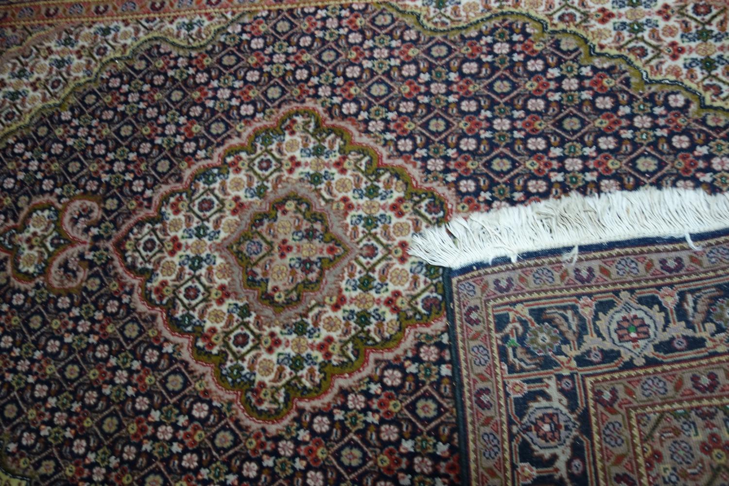 A part silk Tabriz rug, with floral medallion, on a blue and beige ground, contained by floral - Image 3 of 3