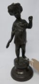 A bronze figure of a standing cherub on socle base. H.26cm