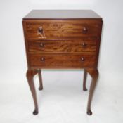 An early 20th century mahogany side chest of three drawers, raised on cabriole legs, H.70 W.46 D.