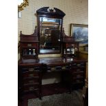 A Victorian mahogany dressing table with 11 drawers, raised on turned legs and castors, H.185 W.