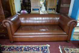 An Edwardian brown leather chesterfield sofa, raised on castors, H.75 W.191 D.88cm