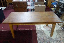 An oak dining table raised on tapered legs, H.74 W.183 D.85cm