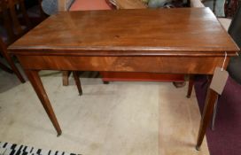 A 19th century mahogany fold over tea table, raised on tapered legs and castors, H.74 W.102 D.51cm