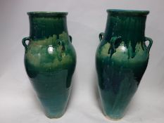 A pair of Persian turquoise glazed Sharab wine vessels, H.74cm (2)