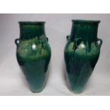 A pair of Persian turquoise glazed Sharab wine vessels, H.74cm (2)