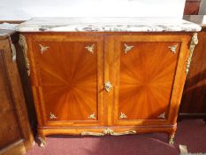 An early 20th century French walnut cabinet, with marble top and gilt metal mounts, the two doors