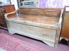 A 19th century Indonesian teak rice bed, with floral carved and slatted backrest, on square legs