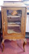 A late 19th century French inlaid walnut vitrine, with glazed hinged lid above glazed door, raised