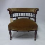 A Victorian rosewood tub chair, raised on turned legs and castors marked 'copes'